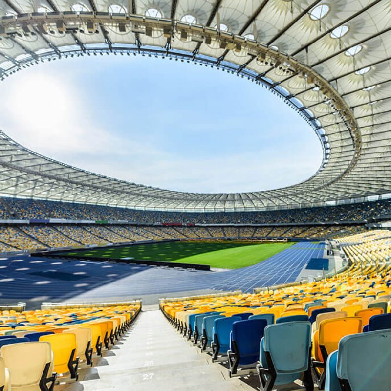 rows-of-yellow-and-blue-stadium-seats-on-soccer-fi-T7AKFMB