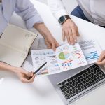 hands-of-two-contemporary-brokers-discussing-finan-LP76AF8