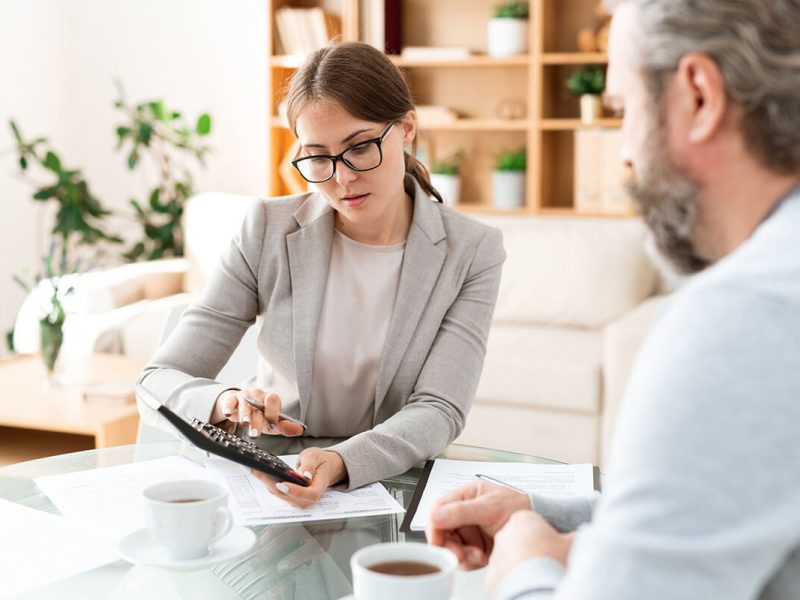 young-accountant-with-calculator-pressing-buttons--9JYPAGM