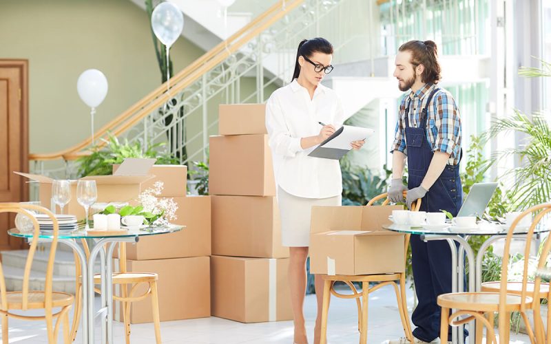 female-restaurant-manager-signing-for-delivery-9PUFDXB