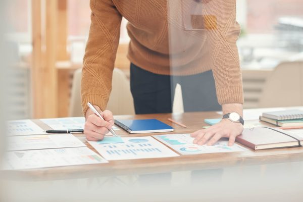 unrecognizable-businessman-planning-project-WNFVM9L