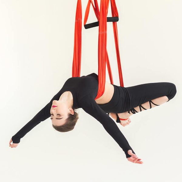 woman-practicing-fly-yoga-over-white-background-FR2QM6N