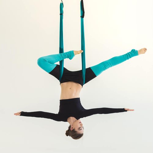 woman-practicing-fly-yoga-over-white-background-JFZCWQL