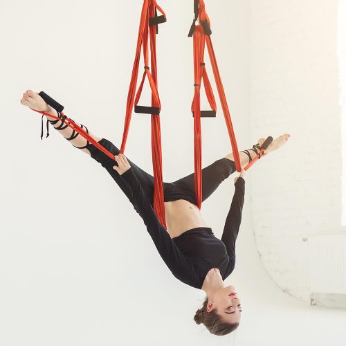 woman-practicing-fly-yoga-over-white-background-PD9LUN7