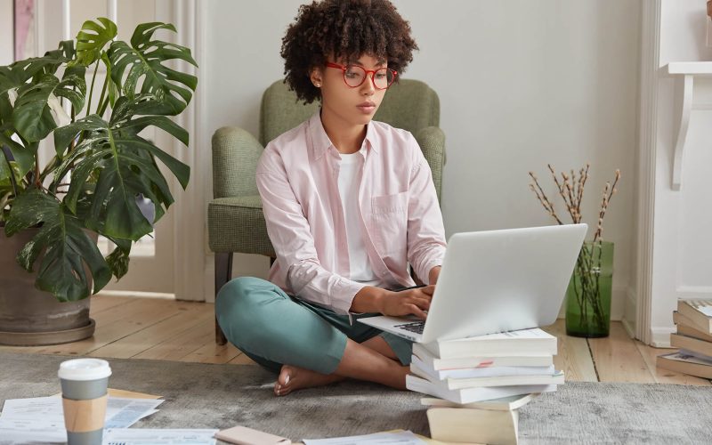 black-businesswoman-keyboards-on-laptop-computer-RXTPFFR