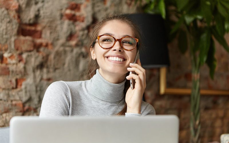 happy-student-girl-enjoying-modern-gadgets-talkin-38V62MX