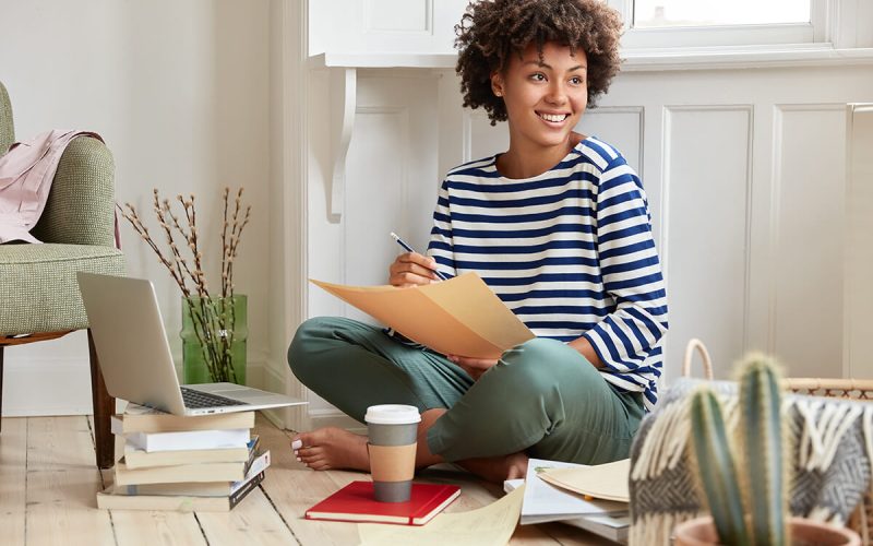 positive-freelancer-with-dark-skin-toothy-smile-ACXJ2GZ