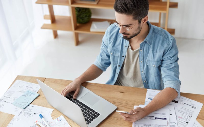 top-view-of-bearded-busy-male-enterpreneur-3EUXWJZ