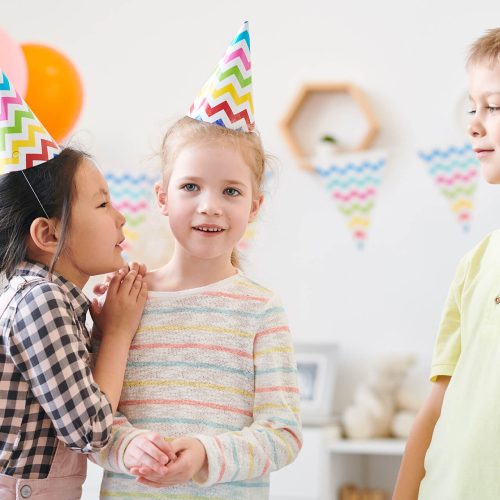 cute-little-girl-whispering-something-to-one-of-he-7DSNM8H